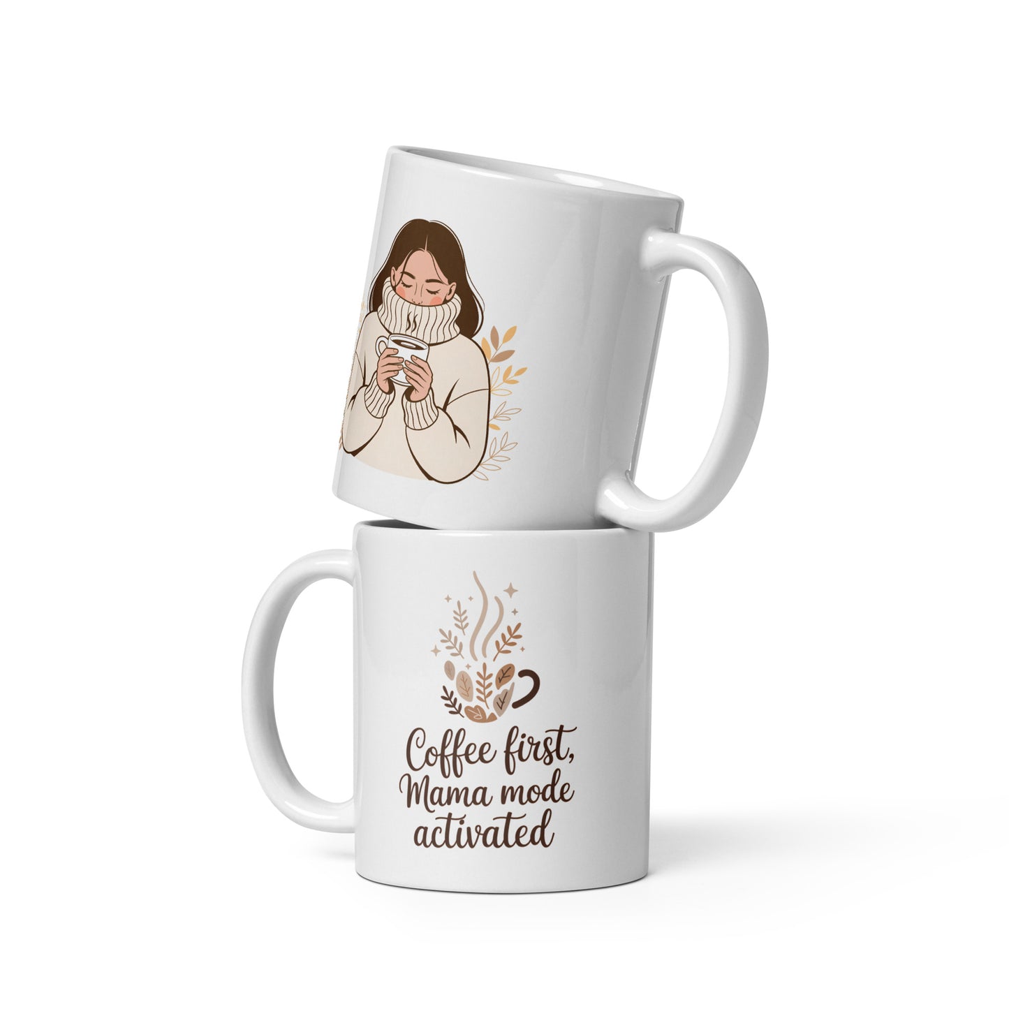 Two stacked white mugs on a white background. One features a cozy illustrated woman in a turtleneck holding coffee, the other displays the quote “Coffee first, Mama mode activated” with autumn leaves and steam.