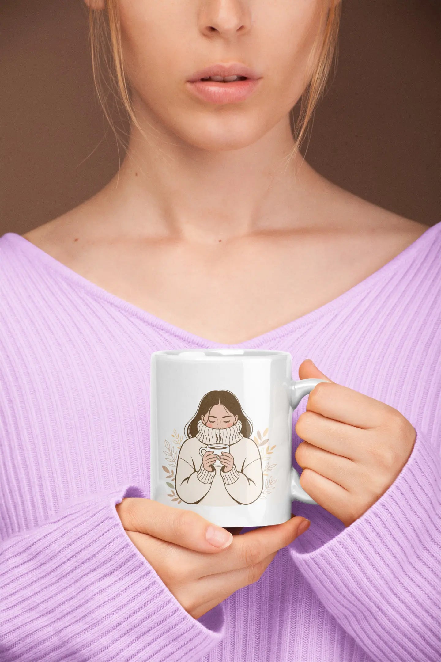 Person holding a mug with a design of a woman holding a coffee mug, wearing a purple sweater.
