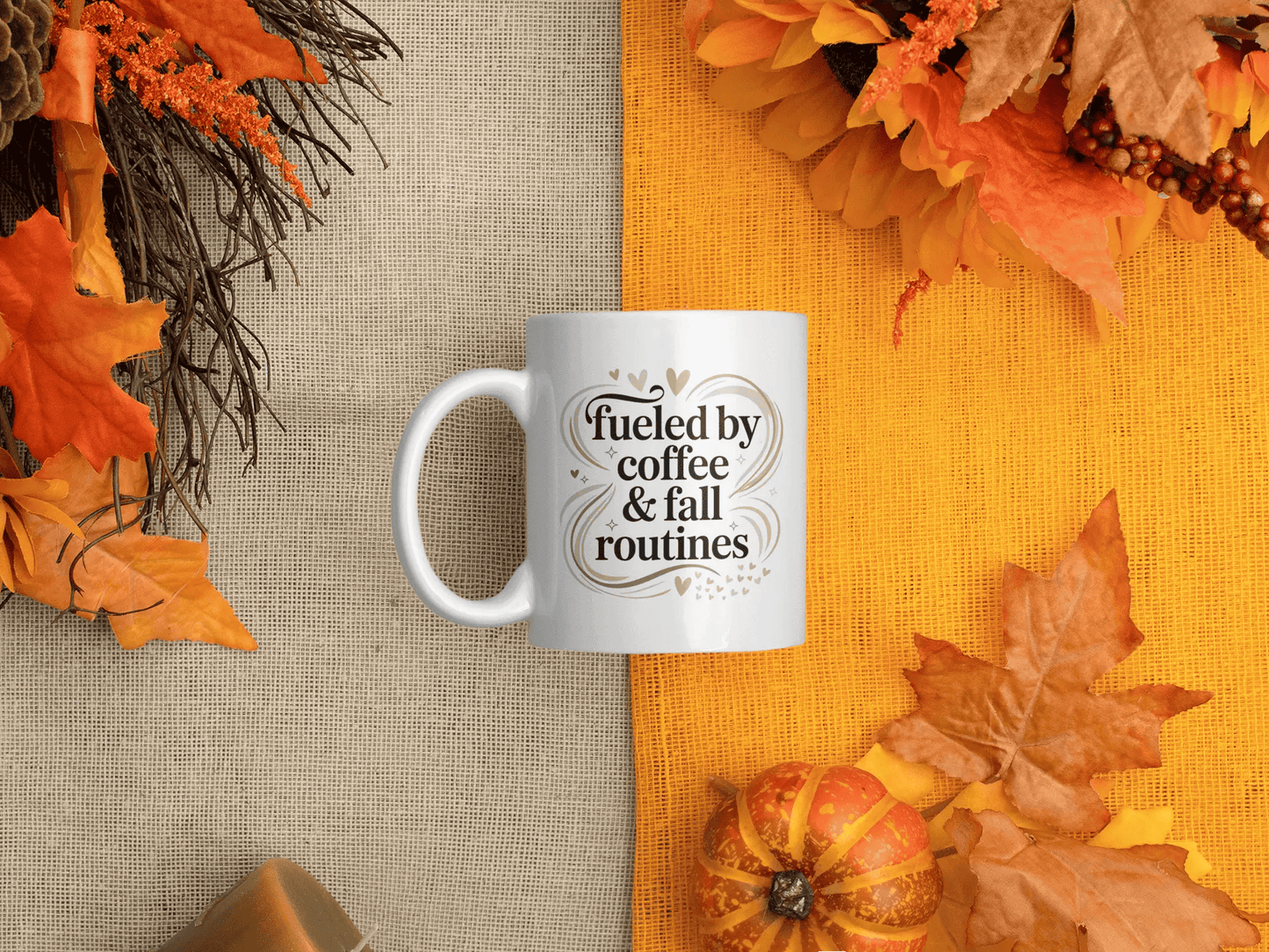 White mug with “Fueled by coffee & fall routines” quote, styled on a cozy autumn background with orange leaves, pumpkins, and warm rustic tones.