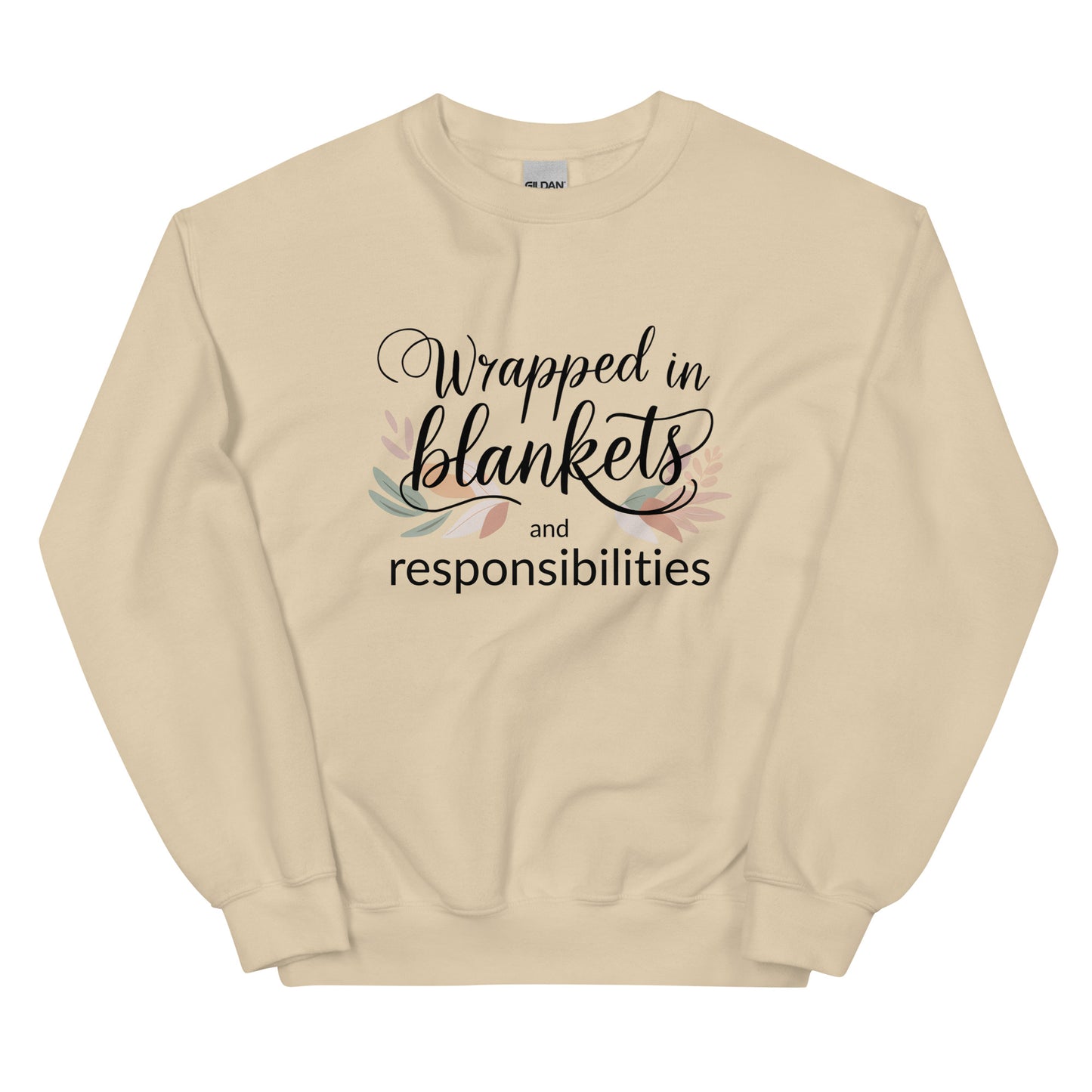 Beige sweatshirt with text 'Wrapped in blankets and responsibilities' on a white background