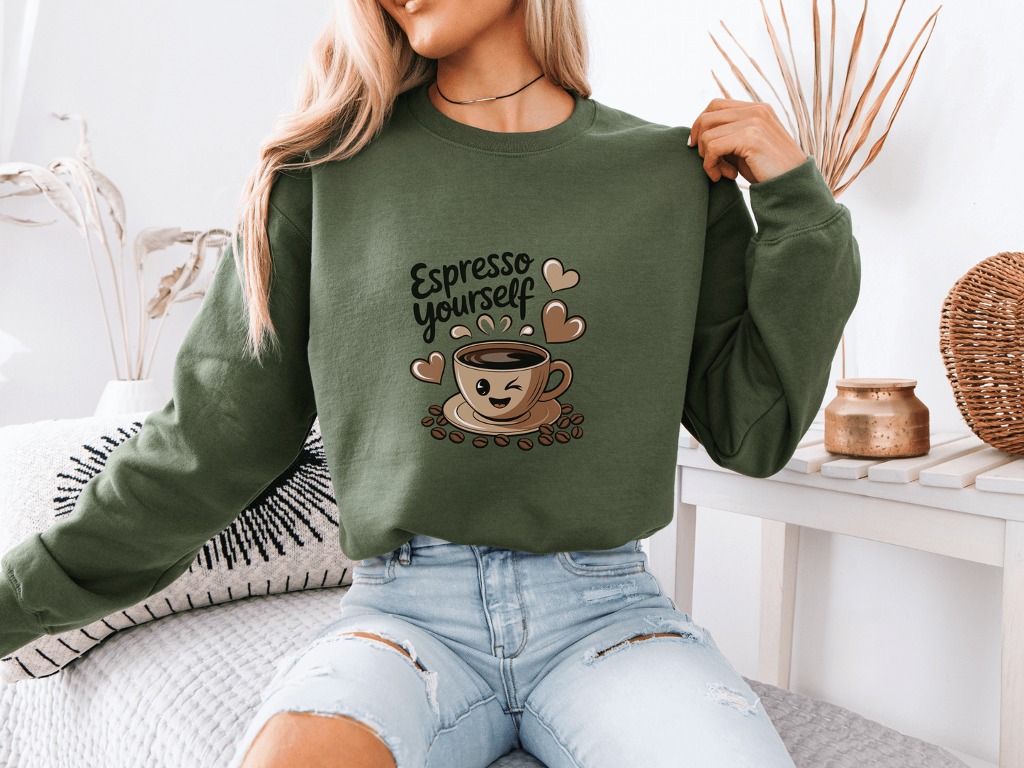 Woman in a military green “Espresso Yourself” sweatshirt featuring a smiling coffee cup with hearts – the perfect cozy gift for coffee-loving moms who run on caffeine and chaos.