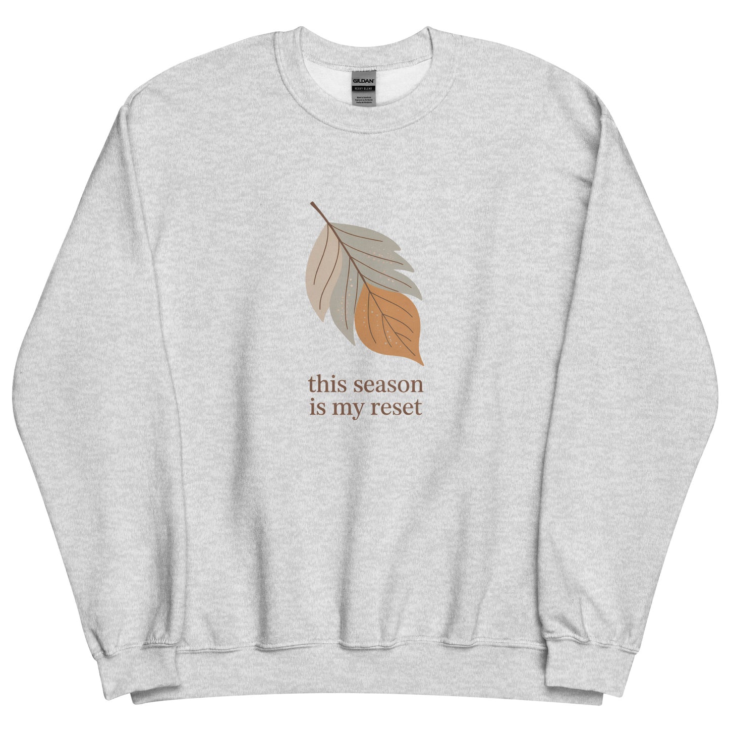 Gray sweatshirt with leaf graphic and text 'this season is my reset' on a white background