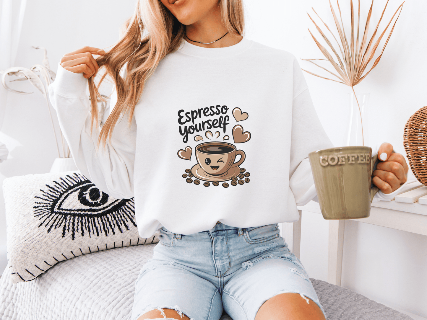 Woman wearing a white “Espresso Yourself” sweatshirt featuring a cute coffee cup with smiling face and hearts – a cozy and funny coffee-themed gift for caffeine-loving moms.
