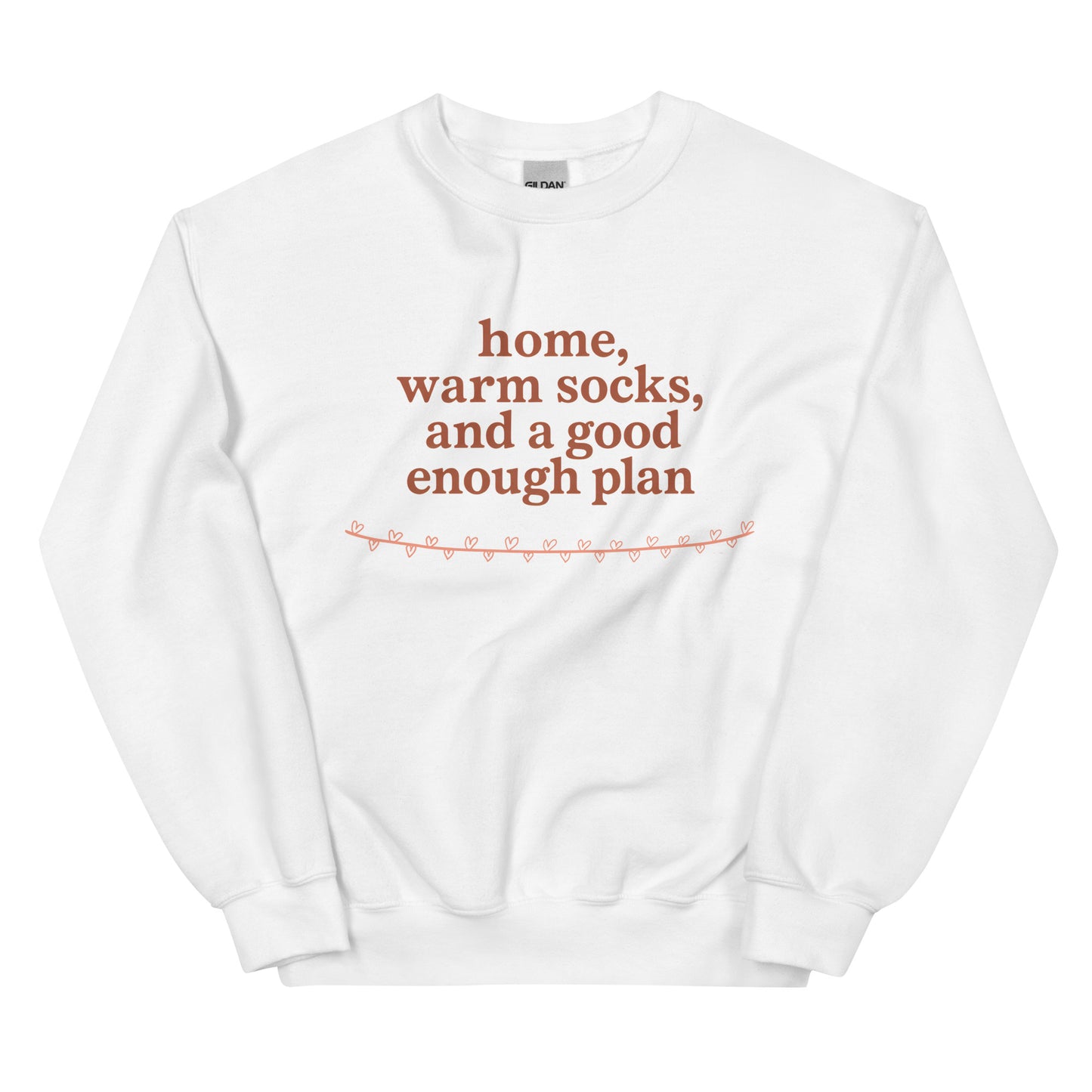 White sweatshirt with red text "home, warm socks, and a good enough plan" on a white background