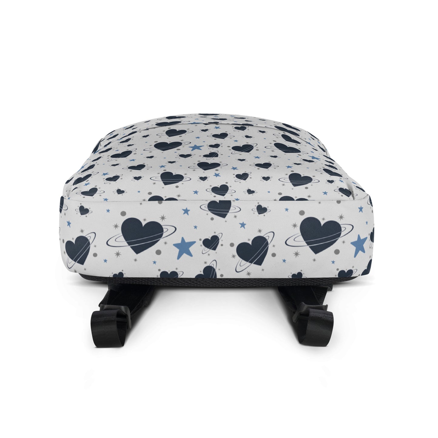 White backpack with all-over navy heart and star pattern, front pocket and visible inside pocket label - bottom