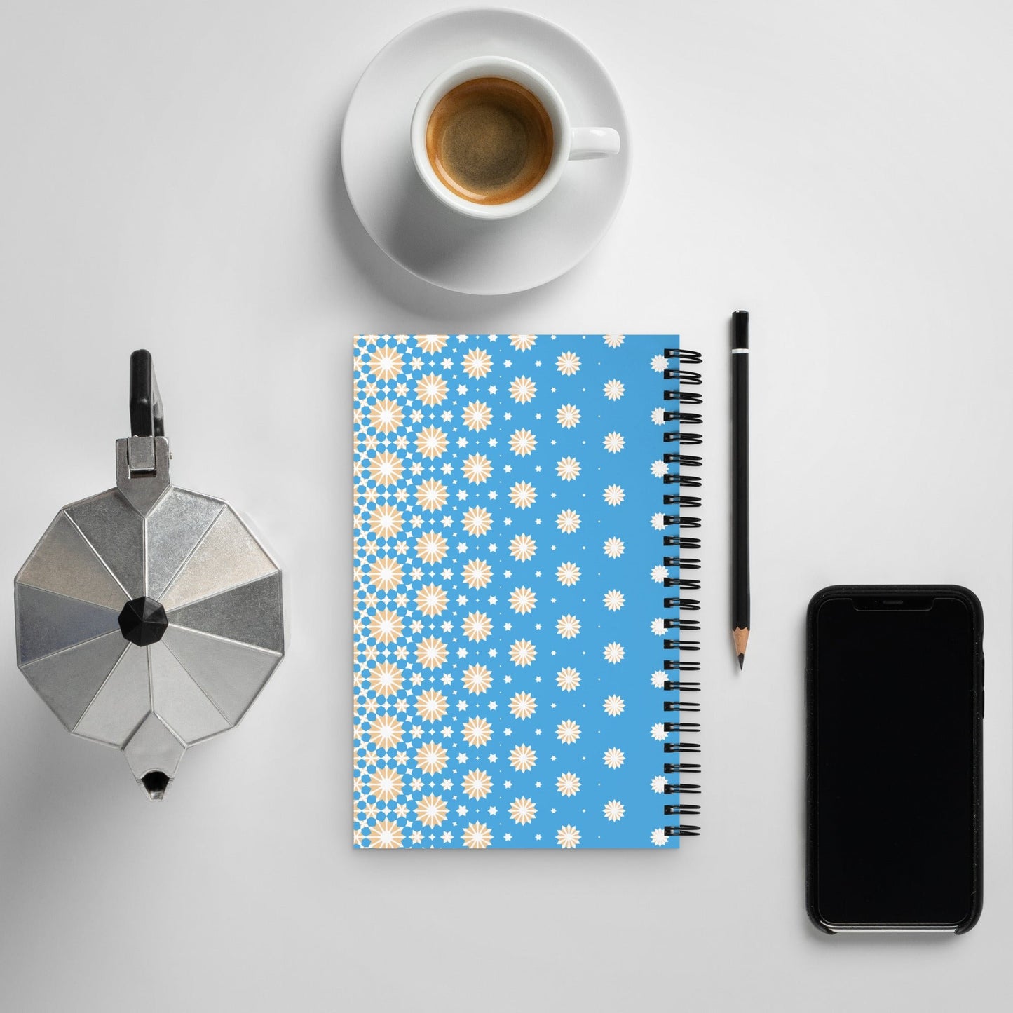 Blue notebook with white and yellow stars pattern – back cover view on cozy desk setup