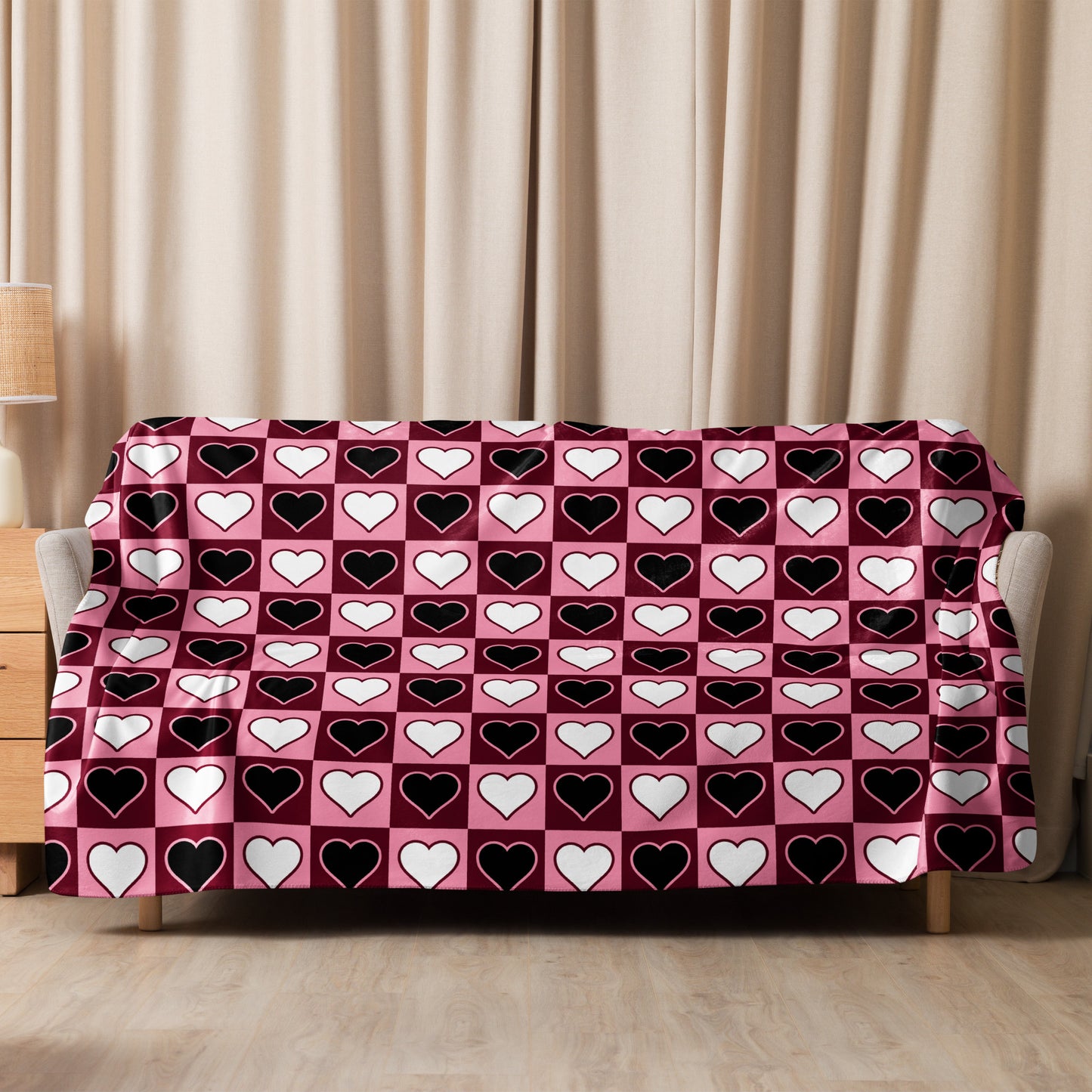 Large heart print sherpa blanket spread across sofa backrest