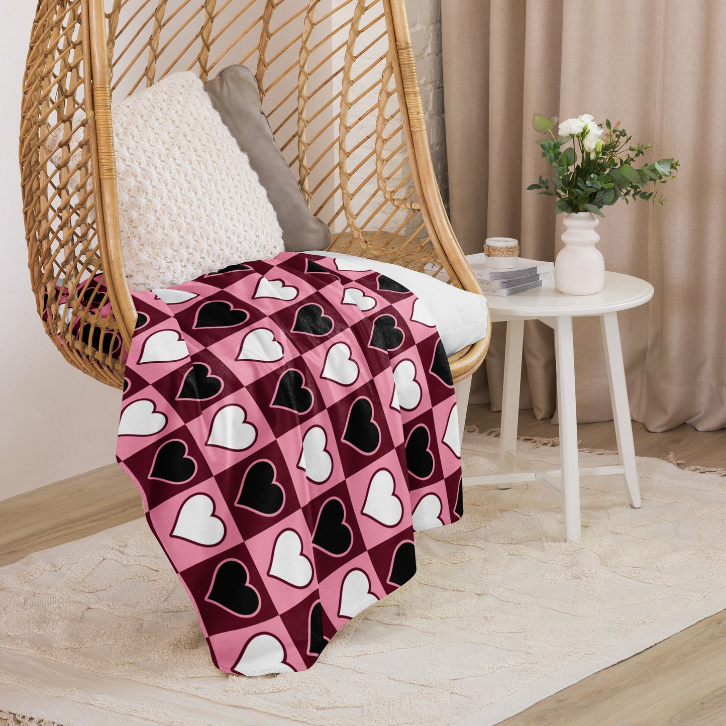 Large heart pattern sherpa blanket shown on a boho-style hanging chair