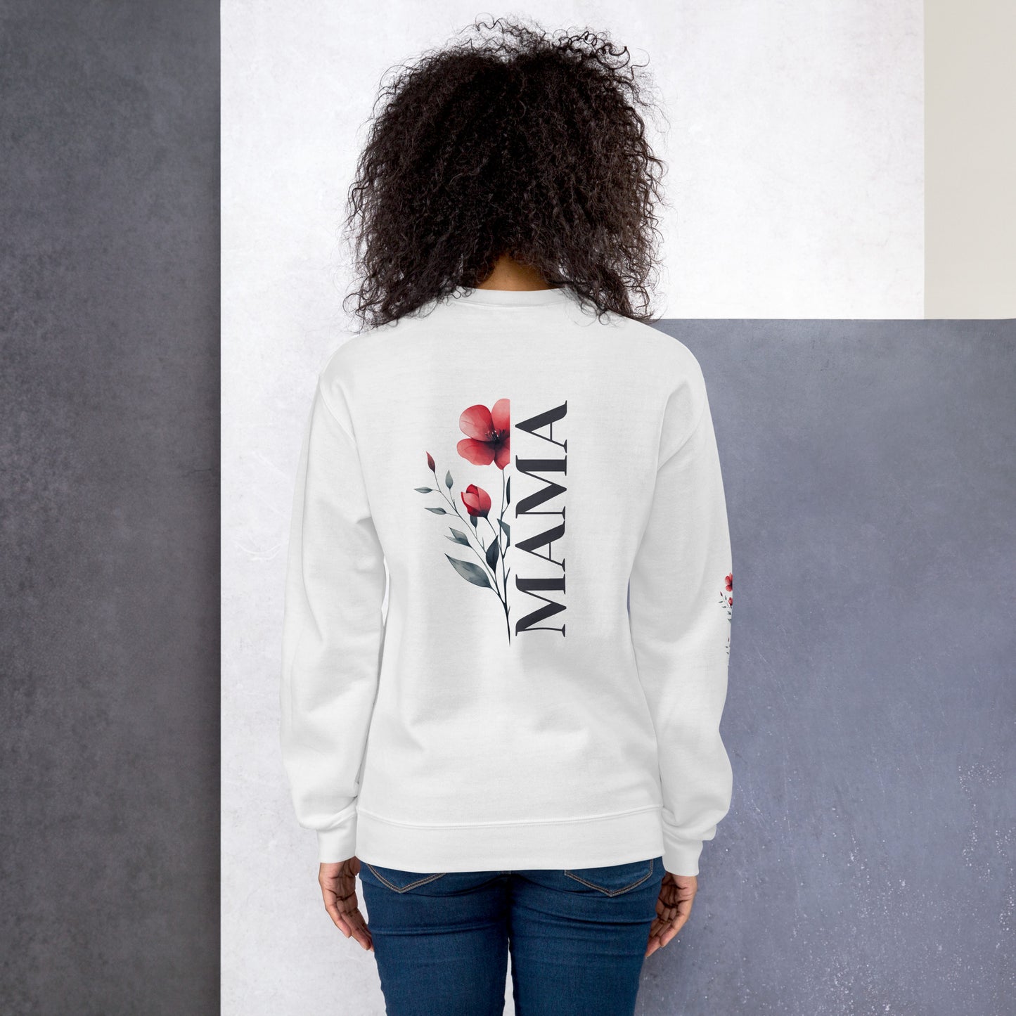 Smiling woman wearing white sweatshirt with floral design detail on the sleeve - back view