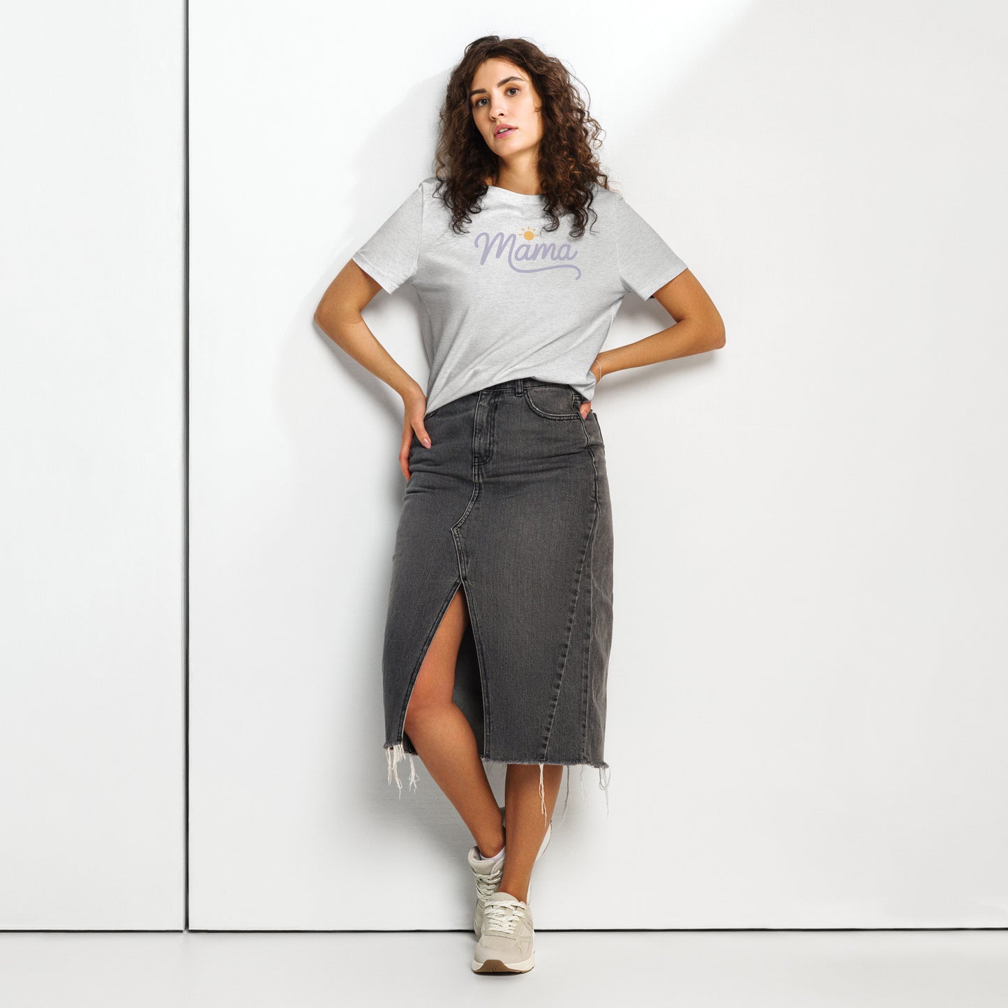 Woman wearing light grey t-shirt with “Mama” script and sun icon, styled with a denim skirt – minimalist summer mom shirt mockup