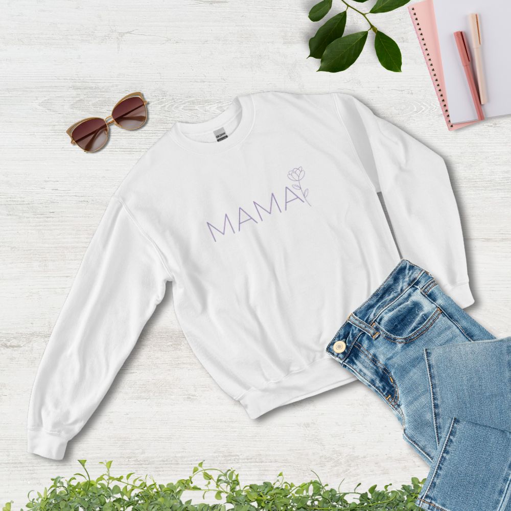 Flat lay of MAMA white sweatshirt styled with jeans, sunglasses, and notebook – cozy and chic gift for moms