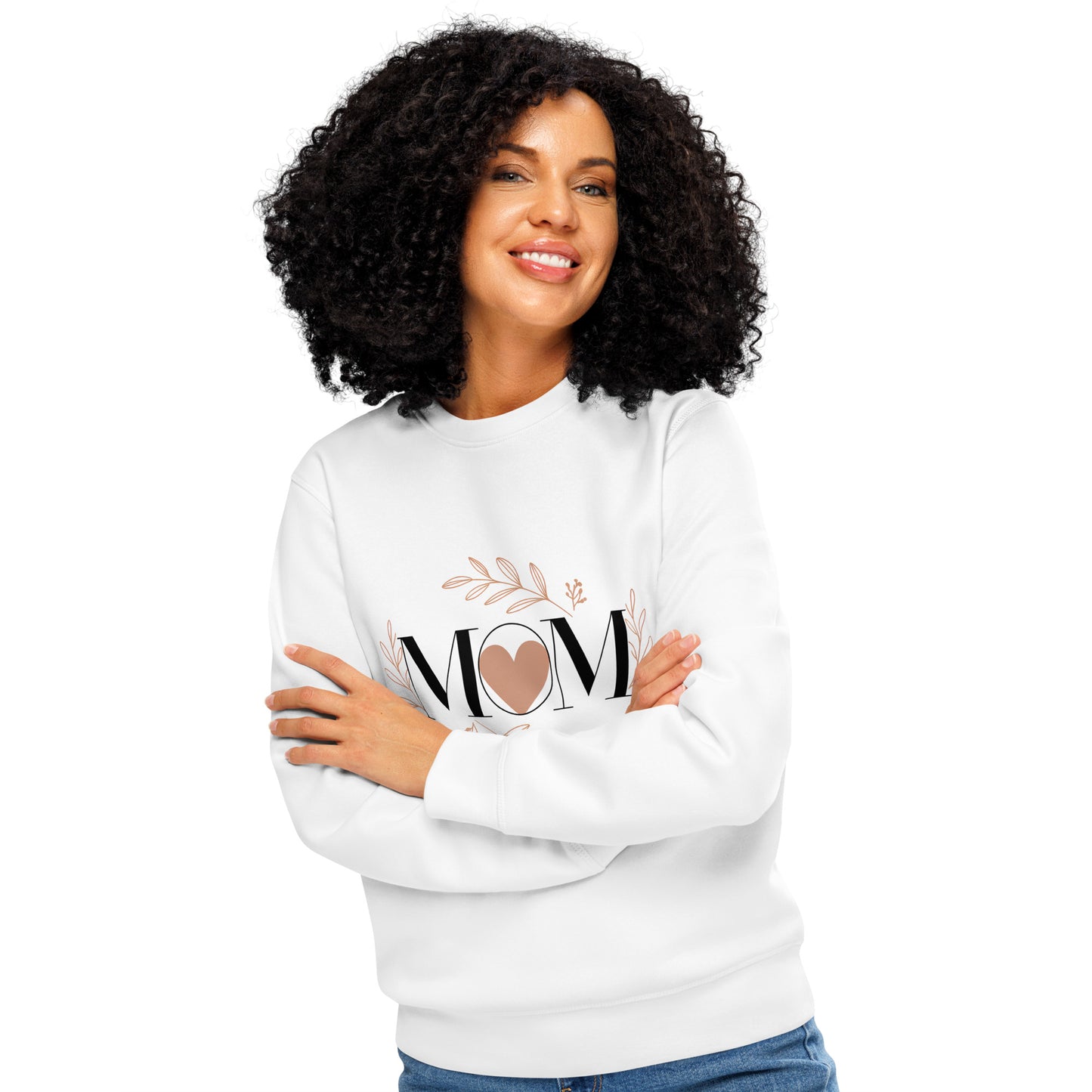 Smiling woman with arms crossed wearing white sweatshirt with 'MOM' heart and floral design.