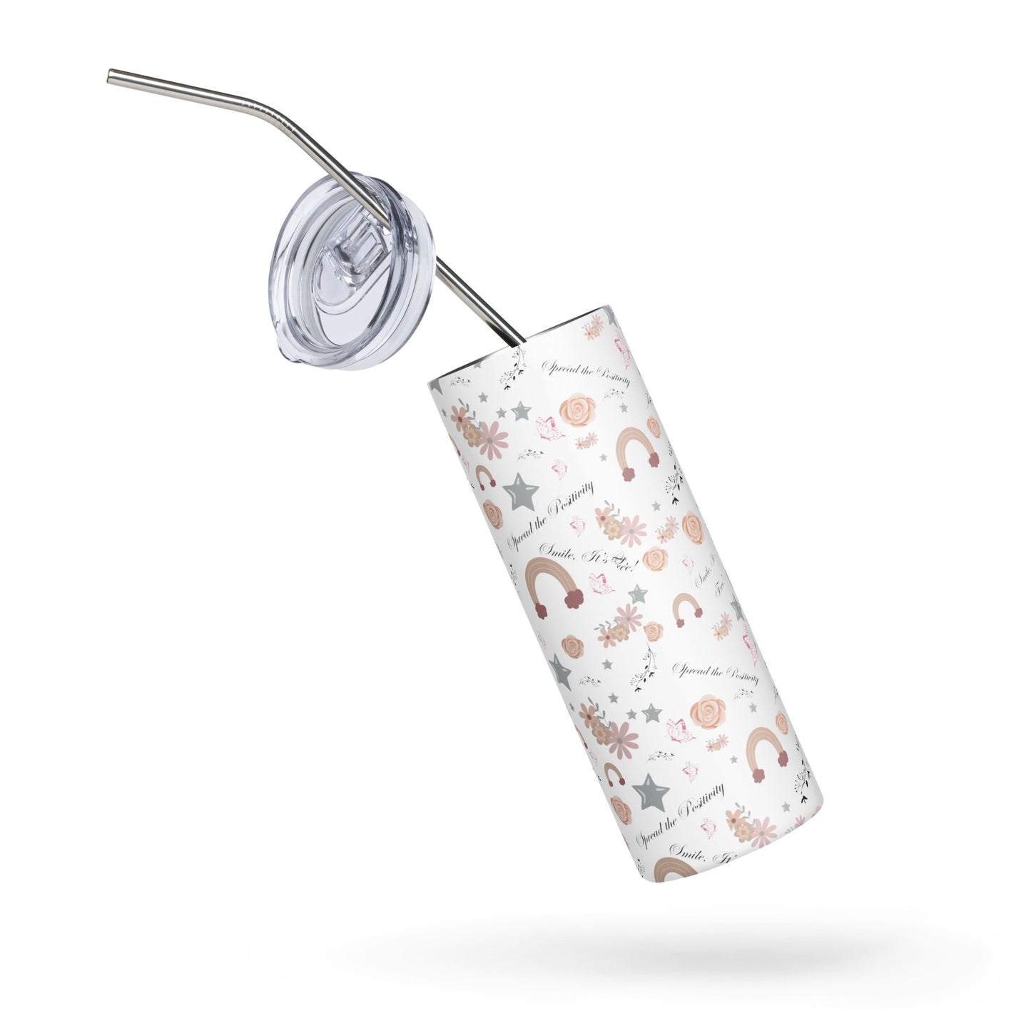Stainless steel tumbler with pastel rainbow and floral pattern, tilted diagonally with a clear lid and metal straw hovering above it, on a white background.
