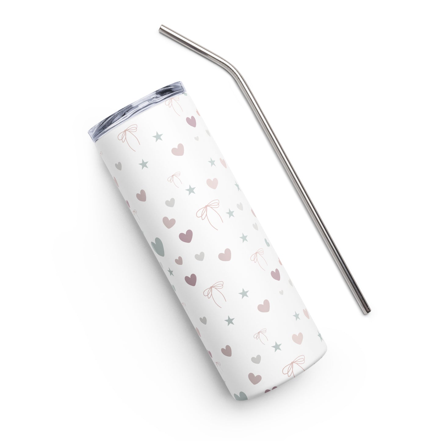 White stainless steel tumbler with pastel heart, star, and bow design, lying at an angle on a white background next to a reusable metal straw.