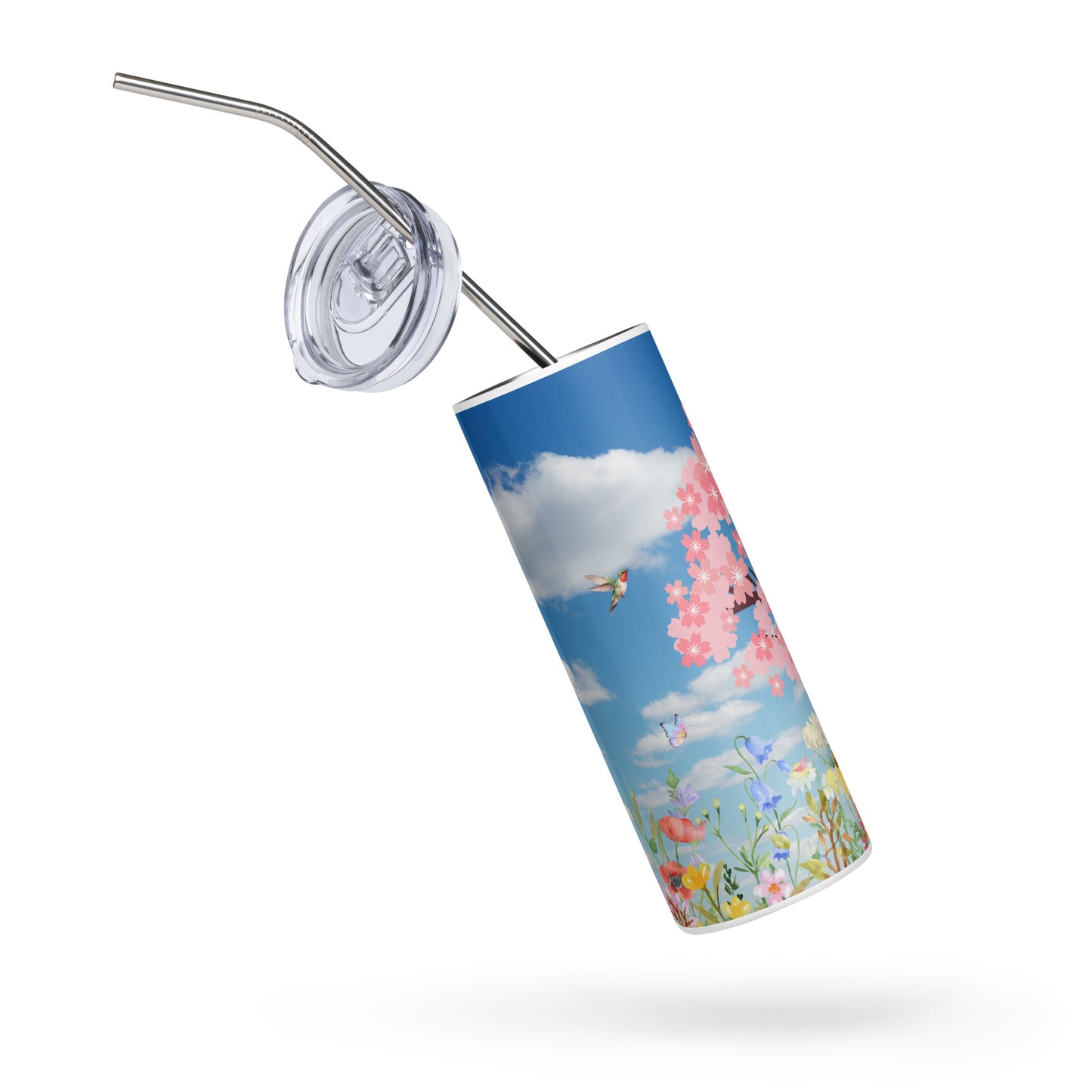 Spring-themed stainless steel tumbler floating at an angle with lid and straw detached, featuring cherry blossoms, butterflies, and wildflowers under a blue sky with clouds on a white background.