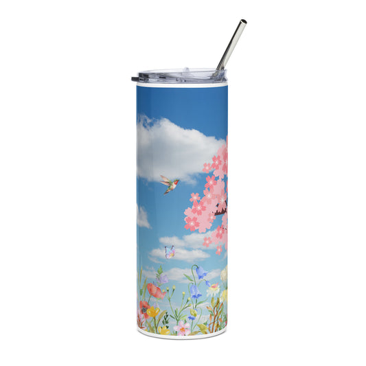 Stainless steel tumbler with metal straw standing upright, featuring cherry blossoms, butterflies, and colorful spring flowers beneath a bright blue sky with clouds.