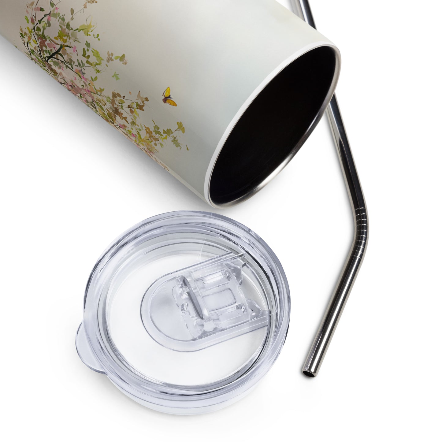 Close-up of a pastel floral stainless steel tumbler with a metal straw and clear lid, shown on a white background.