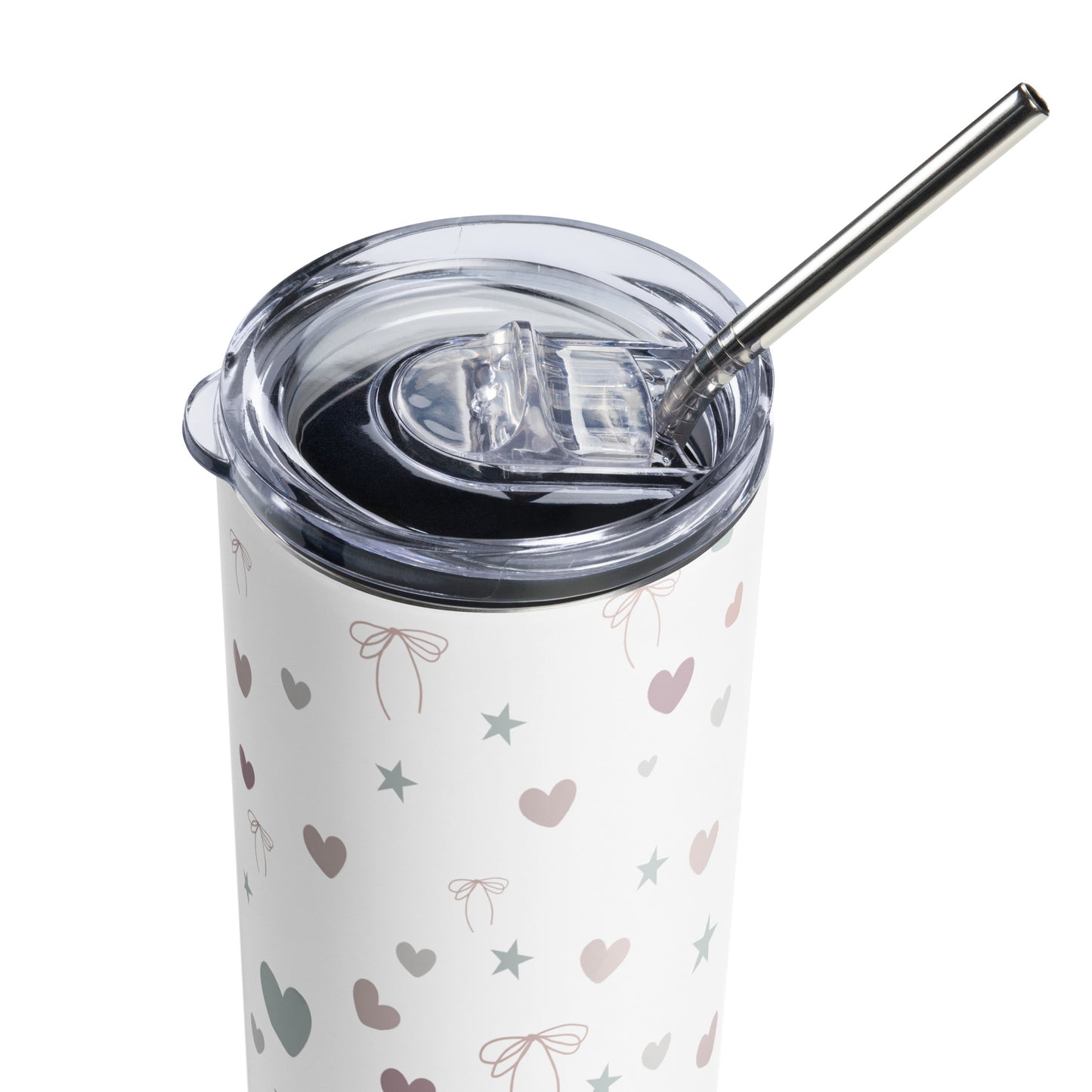 Close-up of a white stainless steel tumbler with pastel hearts, stars, and bows, featuring a clear plastic lid and metal straw.