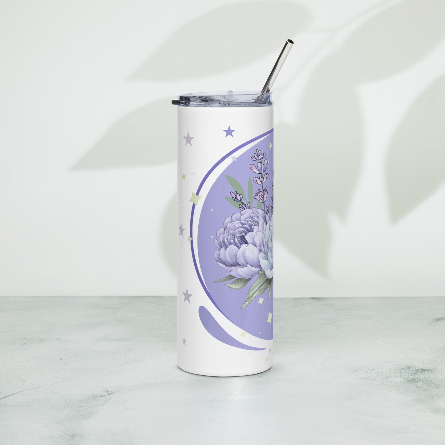 Lavender floral stainless steel tumbler with straw, placed on a white surface with leaf shadows in the background.