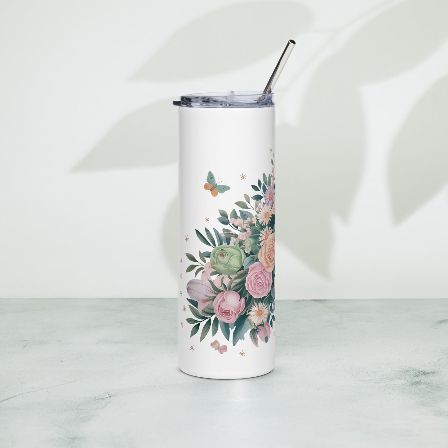 Tall white tumbler with pastel floral, butterfly Includes metal straw and transparent lid.