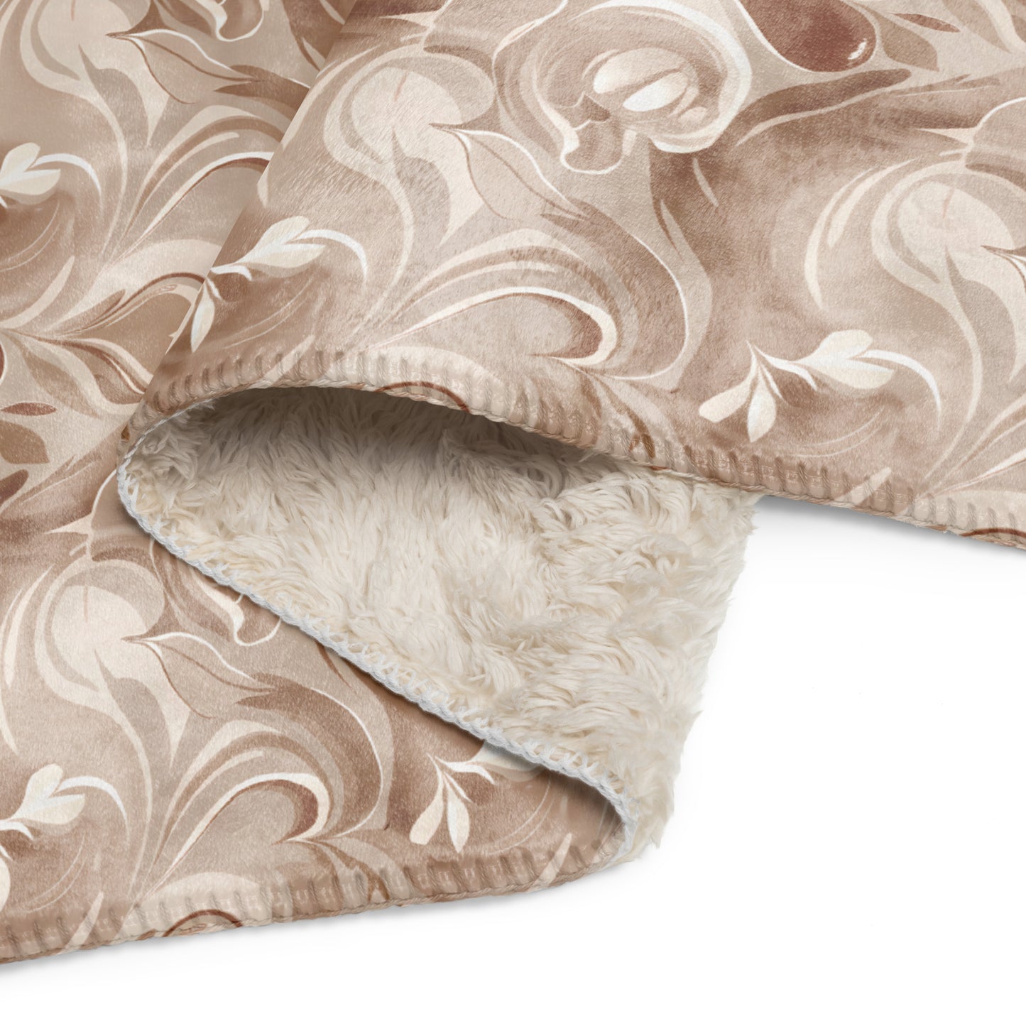 Close-up of tan sherpa blanket with elegant cream coffee-inspired swirl pattern, showing the soft, plush sherpa lining on the inside and smooth printed exterior on the outside.