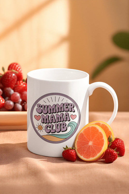 White 11oz mug with Summer Mama Club design on a table with fresh strawberries, grapes, and orange slices in cozy morning light