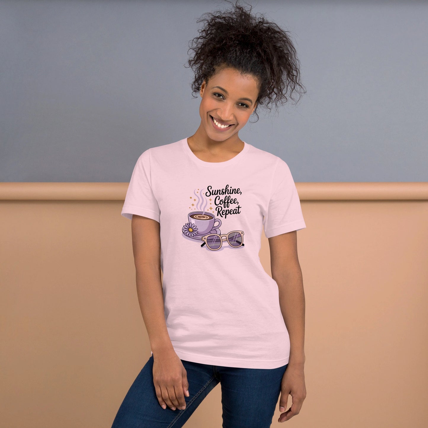 Smiling woman wearing a pink summer t-shirt with cute coffee cup, daisy flower, sunglasses and "Sunshine, Coffee, Repeat" quote.