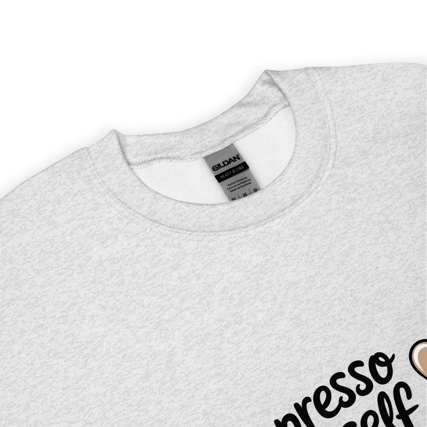 Close-up of a grey crewneck sweatshirt with the phrase “Espresso Yourself” printed in black cursive font and a small coffee cup illustration on the side.
