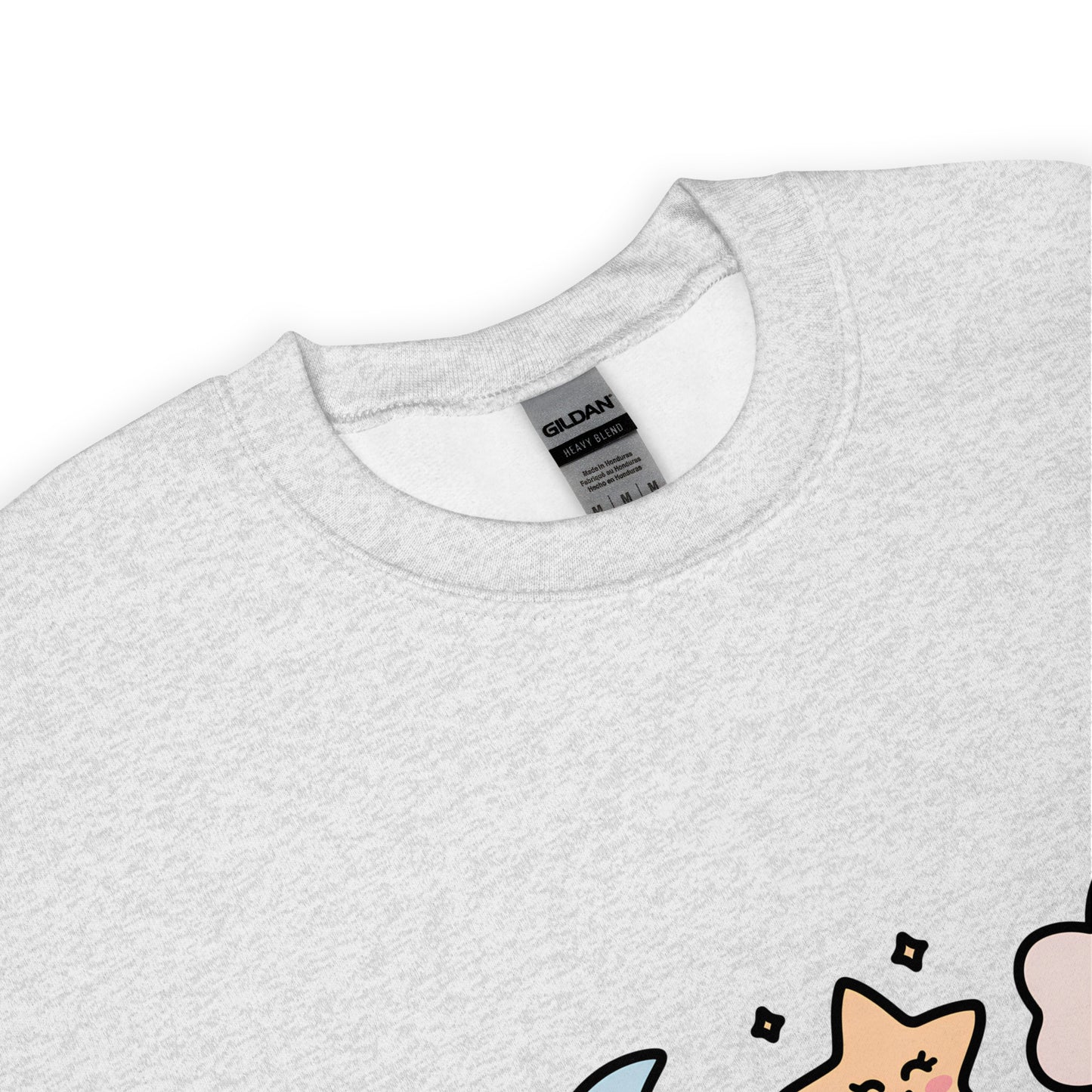 Close-up of the collar and tag of a light gray Gildan crew neck sweatshirt, with a partial view of a colorful star and cloud design at the bottom edge.