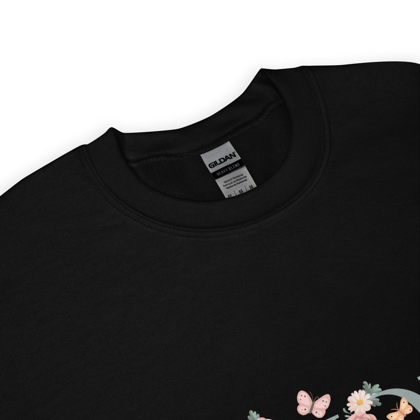 Black crewneck sweatshirt with a close-up of the neckline and a small floral and butterfly design on the lower corner.