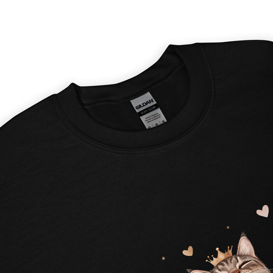 Close-up of a black sweatshirt collar with Gildan label visible and part of a cat graphic wearing a crown with tiny hearts.