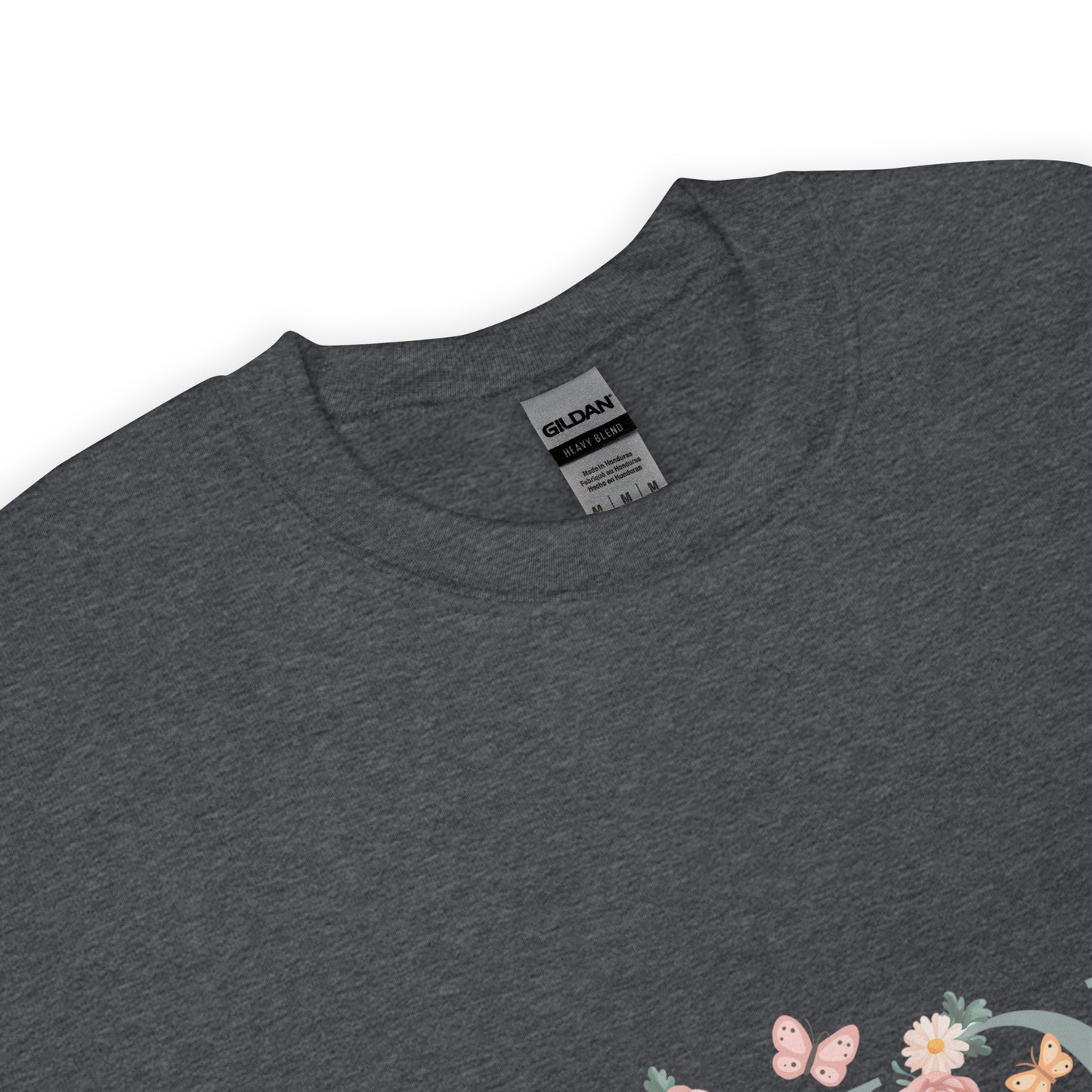 Dark heather gray crewneck sweatshirt with a close-up of the neckline and a small floral and butterfly design on the lower corner.