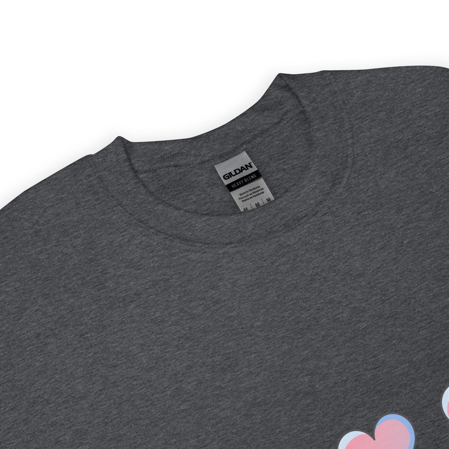 Close-up view of a dark heather crewneck sweatshirt with a soft texture, featuring the top part of a pastel heart design near the hem