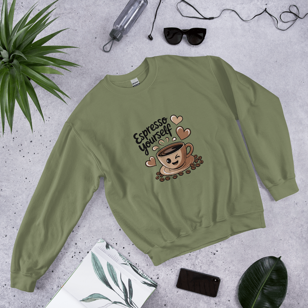 Military green “Espresso Yourself” sweatshirt styled flat lay with sunglasses, water bottle, plant, and notebook – cozy coffee lover gift aesthetic.