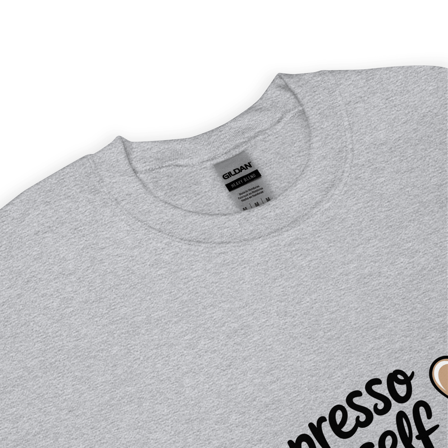 Close-up of a grey crewneck sweatshirt with the phrase “Espresso Yourself” printed in black cursive font and a small coffee cup illustration on the side.