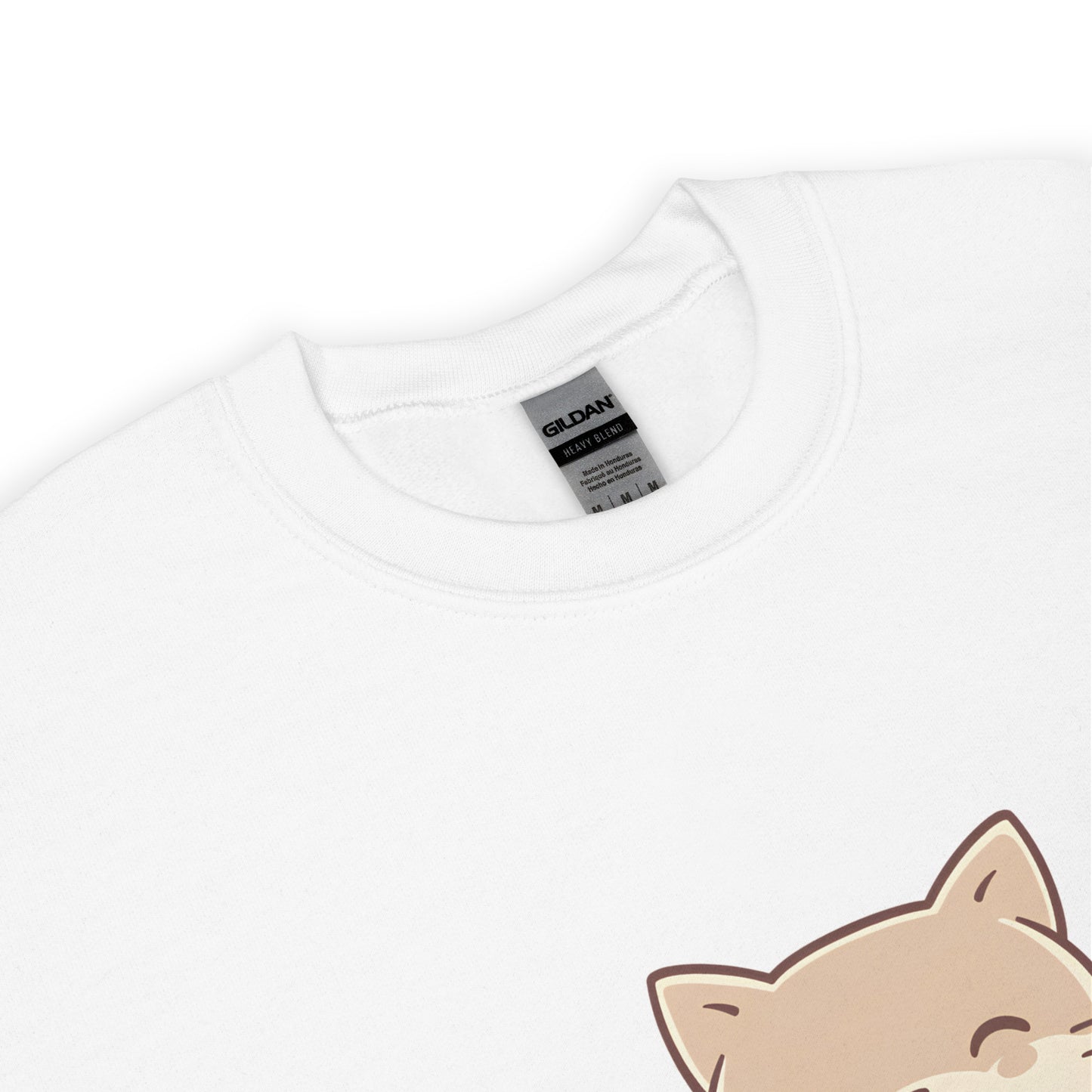 Close-up of the collar and tag of a white Gildan sweatshirt featuring a partial view of a cute cat illustration from the “Stay Kind” design.