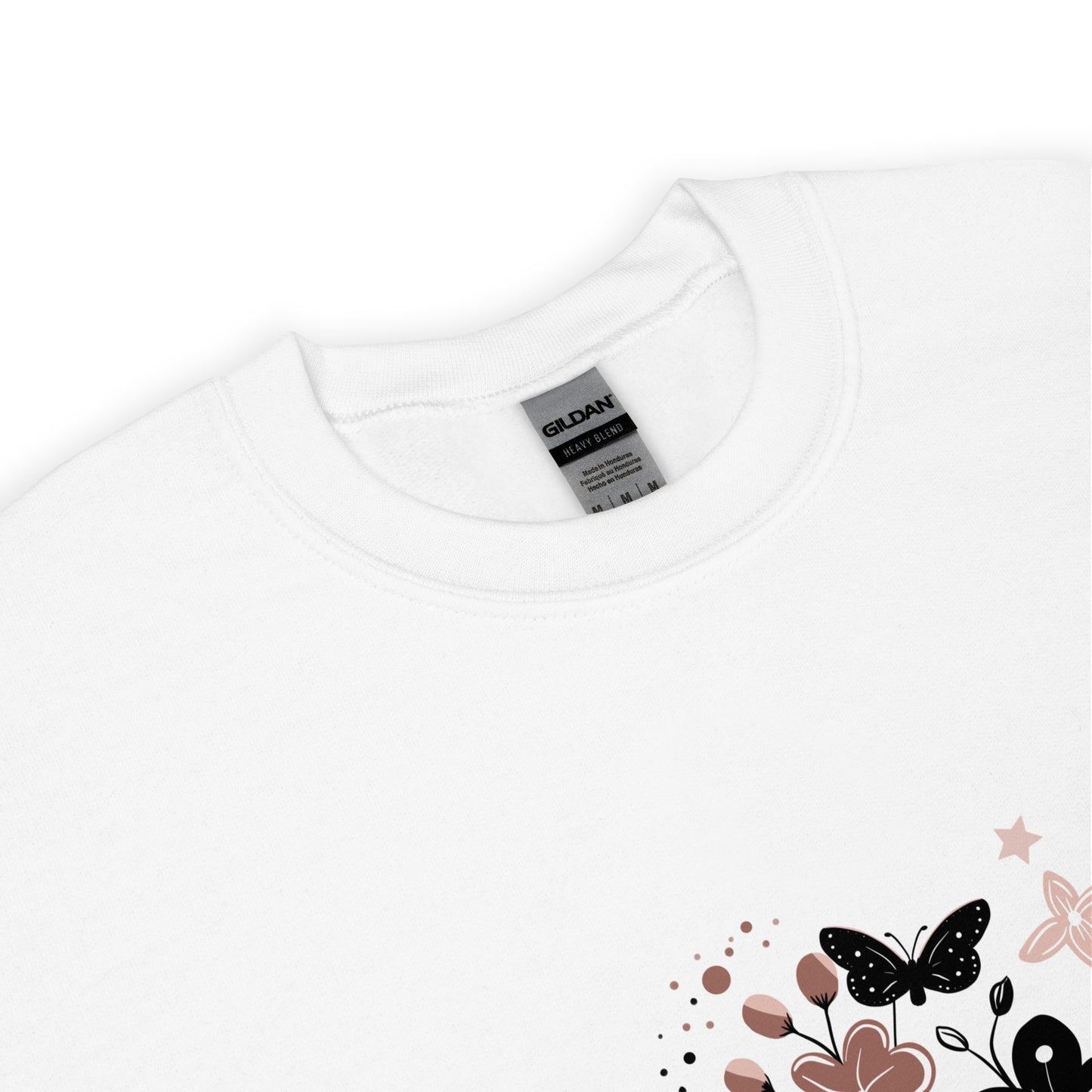 Close-up of a white Gildan sweatshirt with a floral and butterfly design printed on the lower corner, showing the collar and fabric texture.