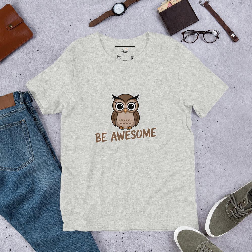 Flat lay of a heather gray t-shirt with a cute owl and “Be Awesome” text – styled with jeans, shoes, and accessories.