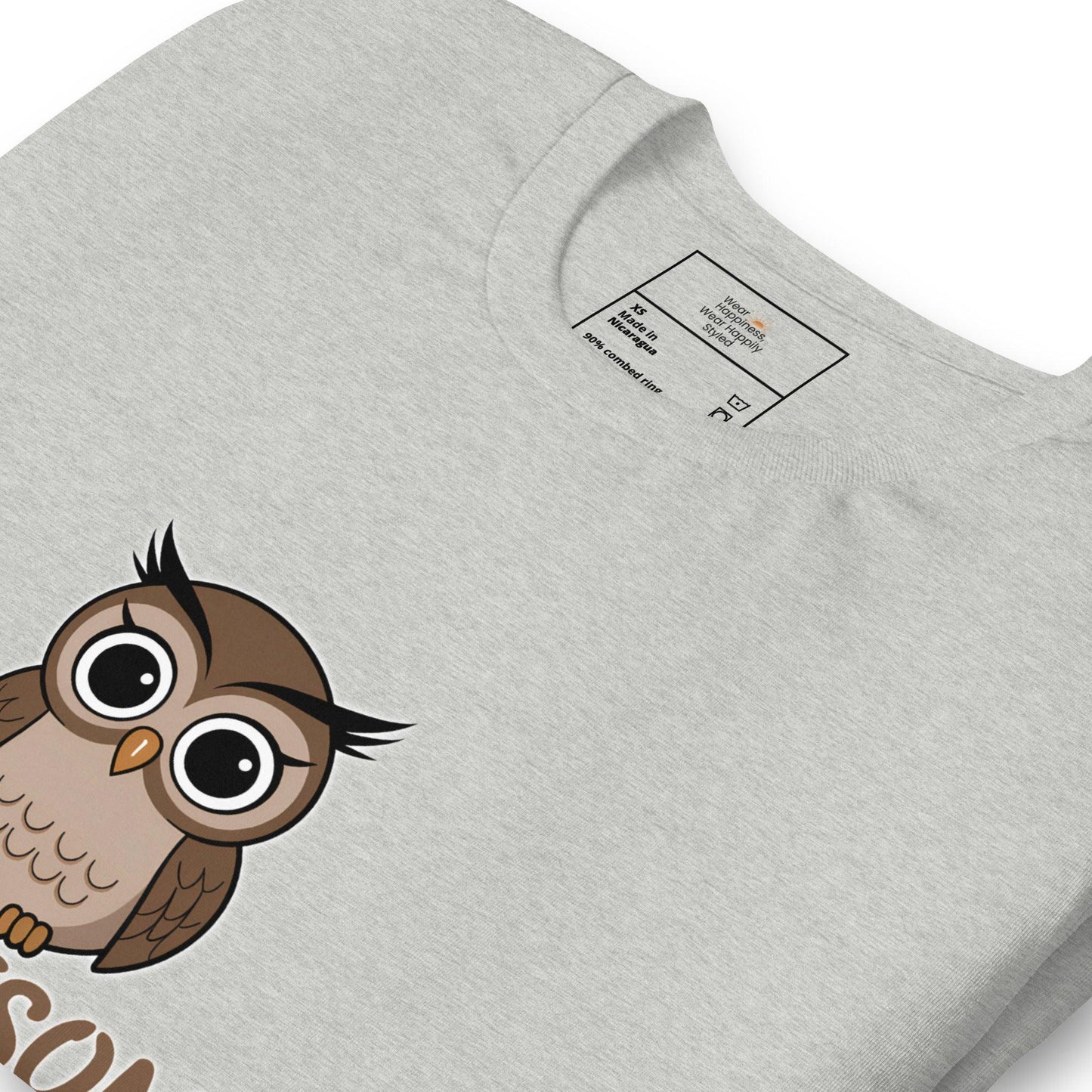 Close-up of a grey t-shirt with a cute cartoon owl graphic peeking from the bottom – whimsical and fun design for owl lovers.