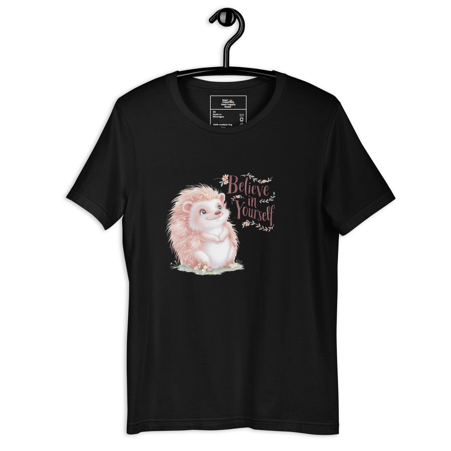 Hanging black t-shirt with a pastel hedgehog and “Believe in Yourself” quote