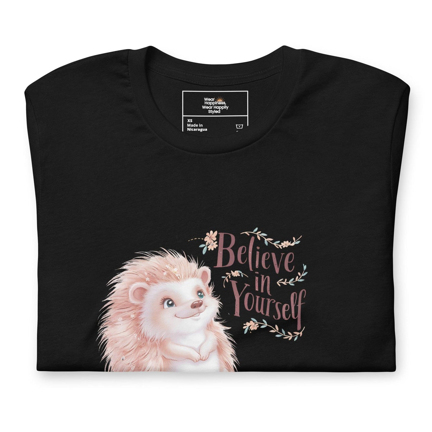 Folded black t-shirt with a cute pastel hedgehog and “Believe in Yourself” quote – inspirational gift for moms.