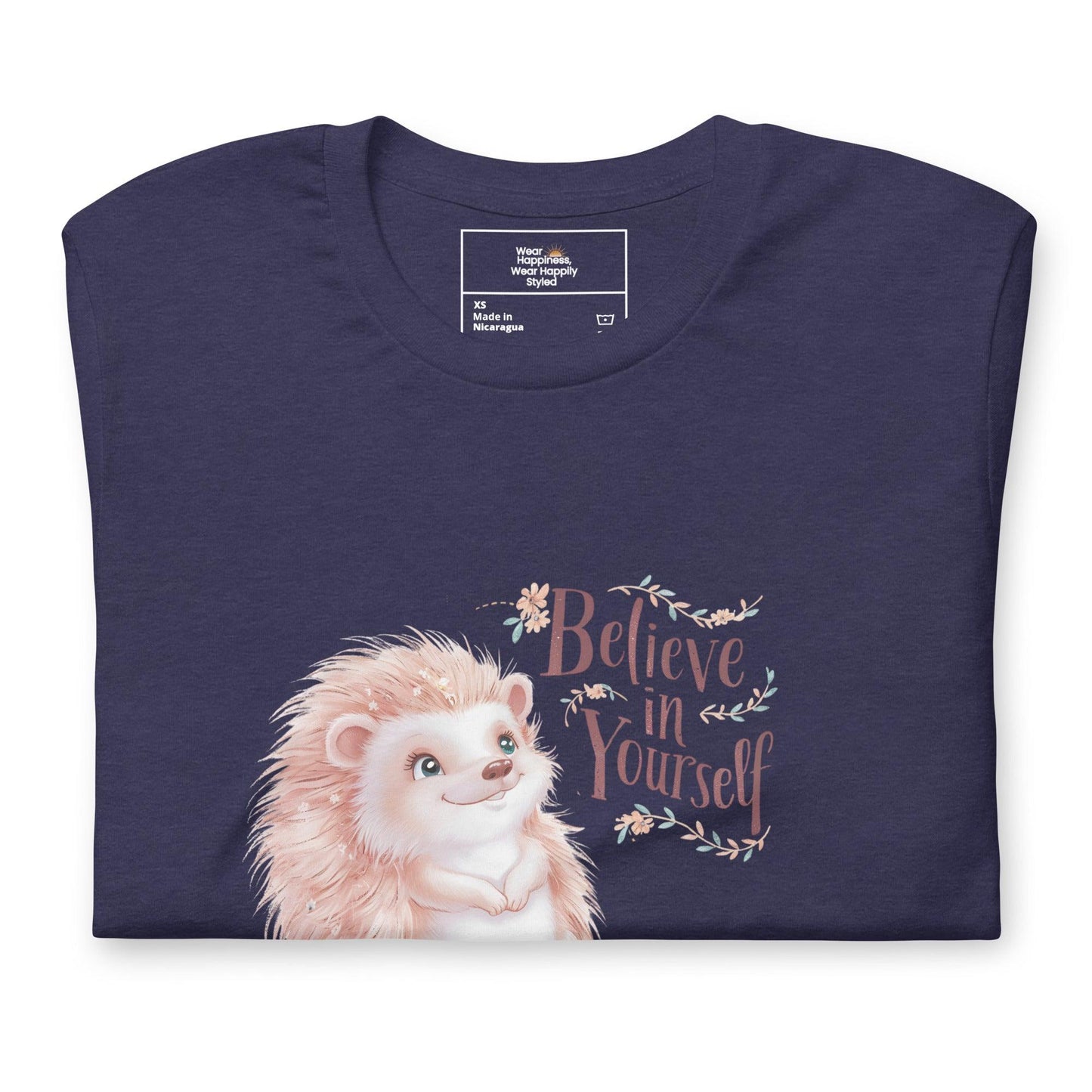 Folded navy blue t-shirt with a cute pastel hedgehog and “Believe in Yourself” quote – inspirational gift for moms.
