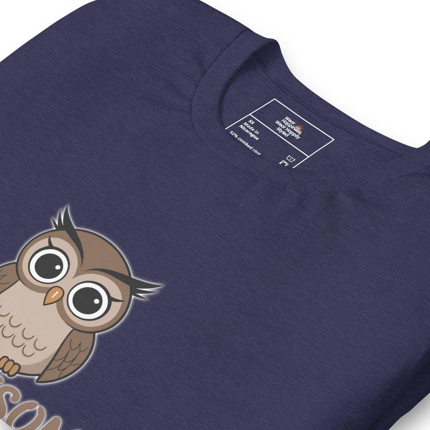 Close-up of a navy blue t-shirt with a cute cartoon owl graphic peeking from the bottom – whimsical and fun design for owl lovers.