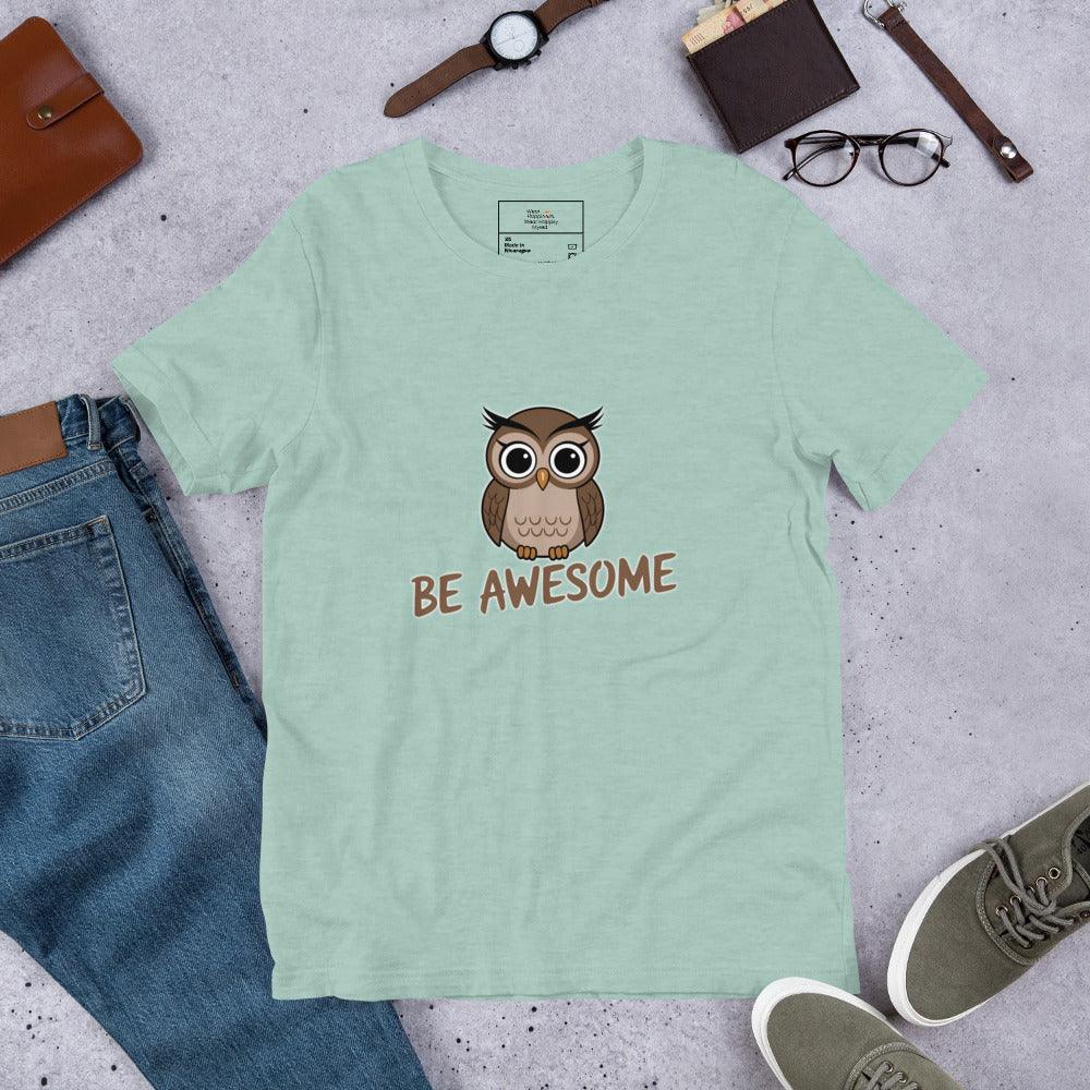Flat lay of a dusty blue t-shirt with a cute owl and “Be Awesome” text – styled with jeans, shoes, and accessories.