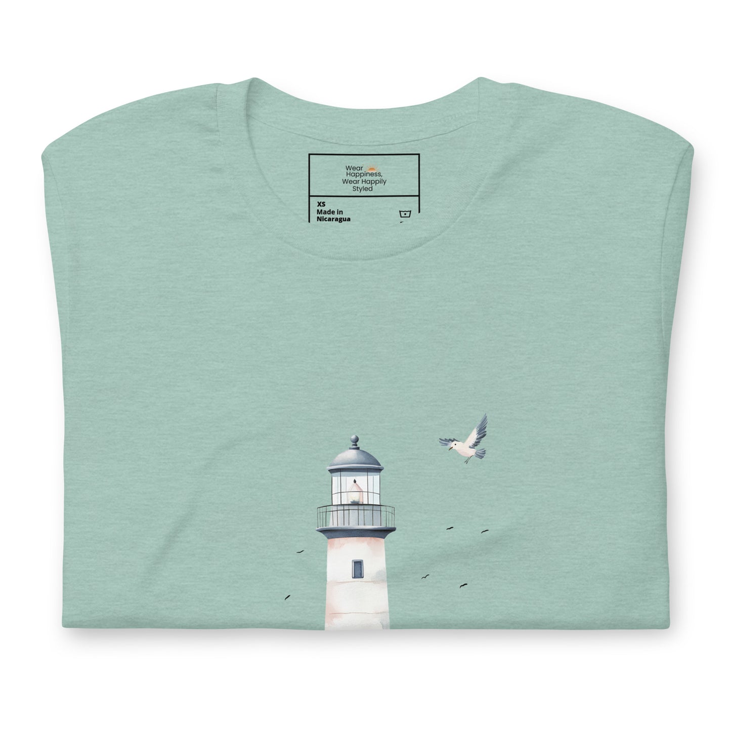 Flat-lay of a folded dusty blue-colored t-shirt featuring a minimal lighthouse and seagull design, styled for a calming, nature-inspired mom aesthetic.