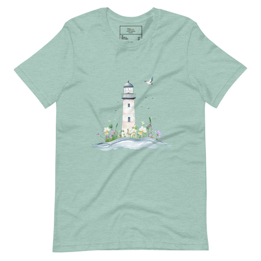 Dusty blue-colored t-shirt laid flat featuring a serene lighthouse illustration with floral details and a seagull in flight, designed for peaceful mom style.
