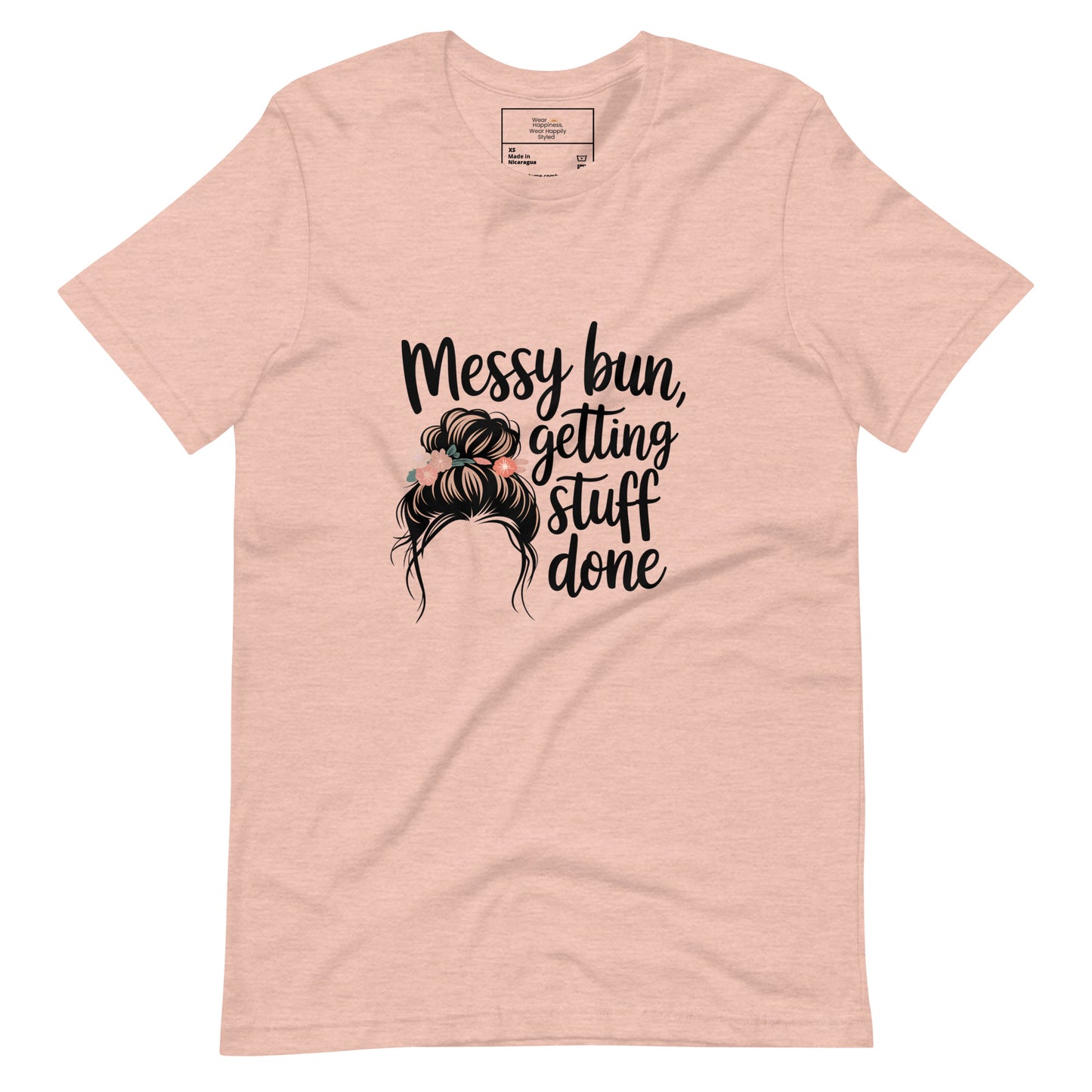 A heather peach t-shirt with black text that says 'Messy Bun, Getting Stuff Done' and a messy bun illustration on a white background