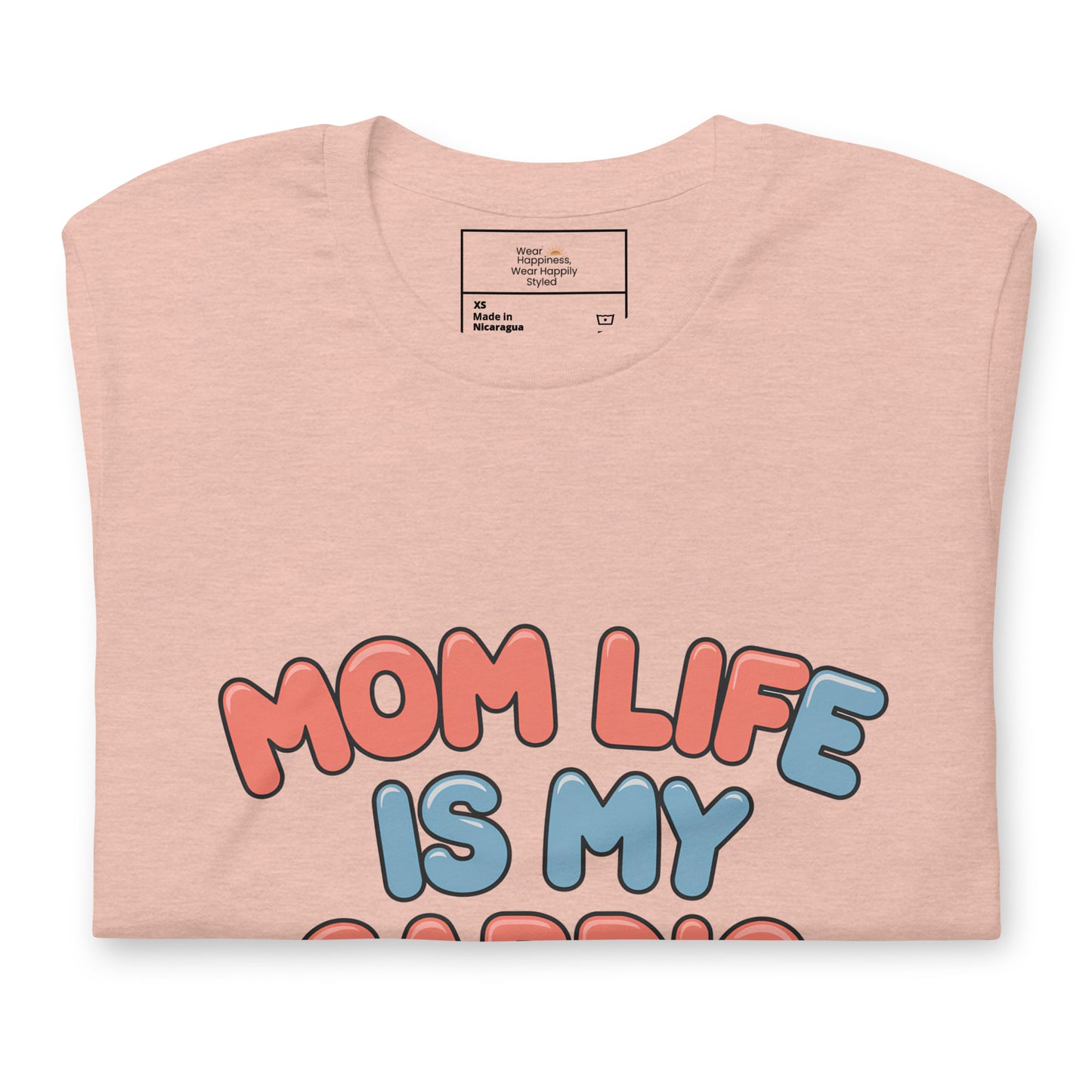 Heather peach t-shirt neatly folded with a colorful design that reads 'Mom Life Is My Cardio' in pink and blue letters, partially visible across the chest area.