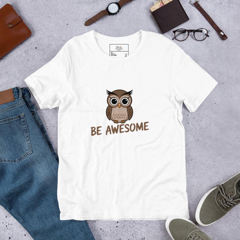 Flat lay of a white t-shirt with a cute owl and “Be Awesome” text – styled with jeans, shoes, and accessories.