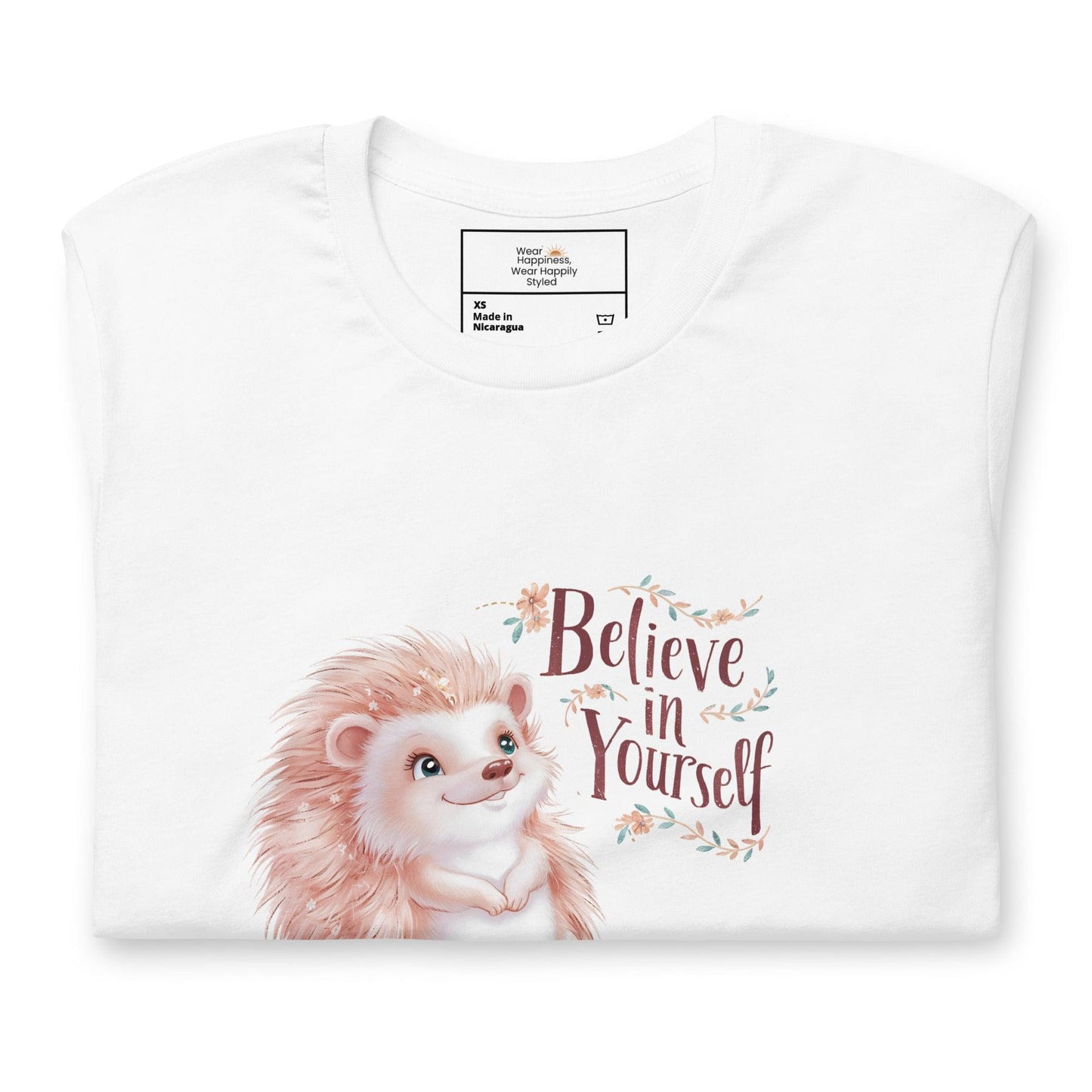 Folded white t-shirt with a cute pastel hedgehog and “Believe in Yourself” quote – inspirational gift for moms.